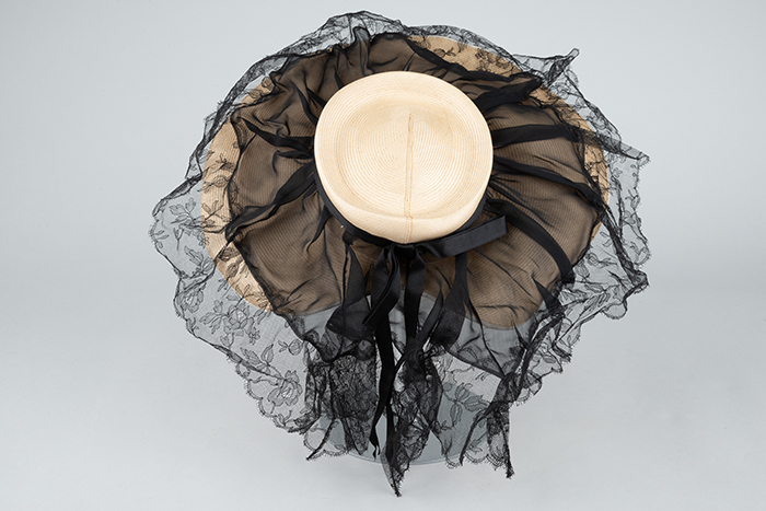 Image of Cream colored straw hat with black lace, 1947
